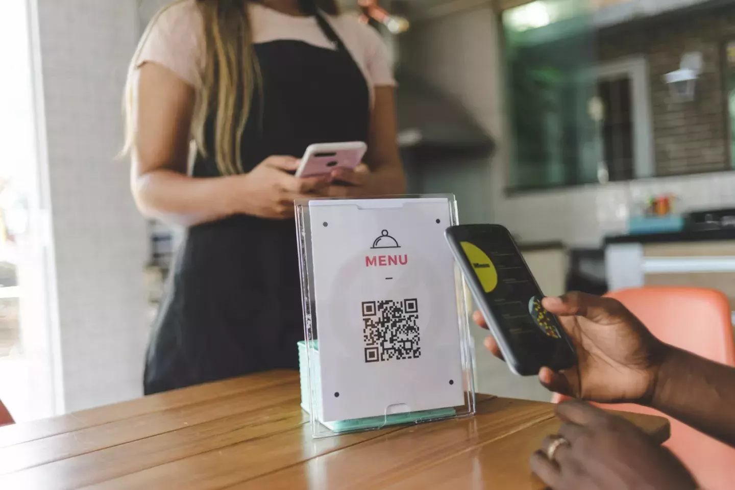 Customer scanning QR code at restaurant