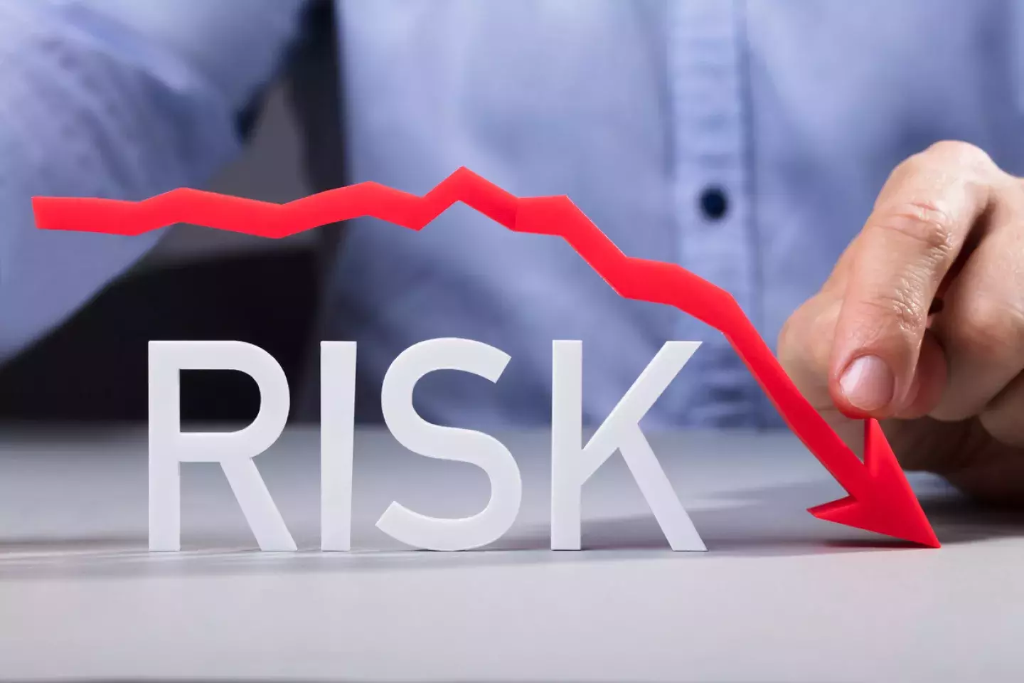 Risk with red arrow going down 