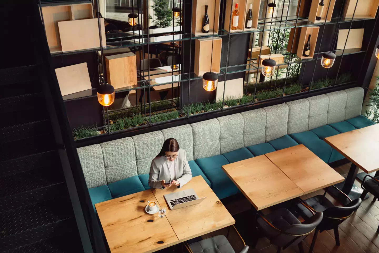 Aerial view of woman in a cafe sitting with her laptop