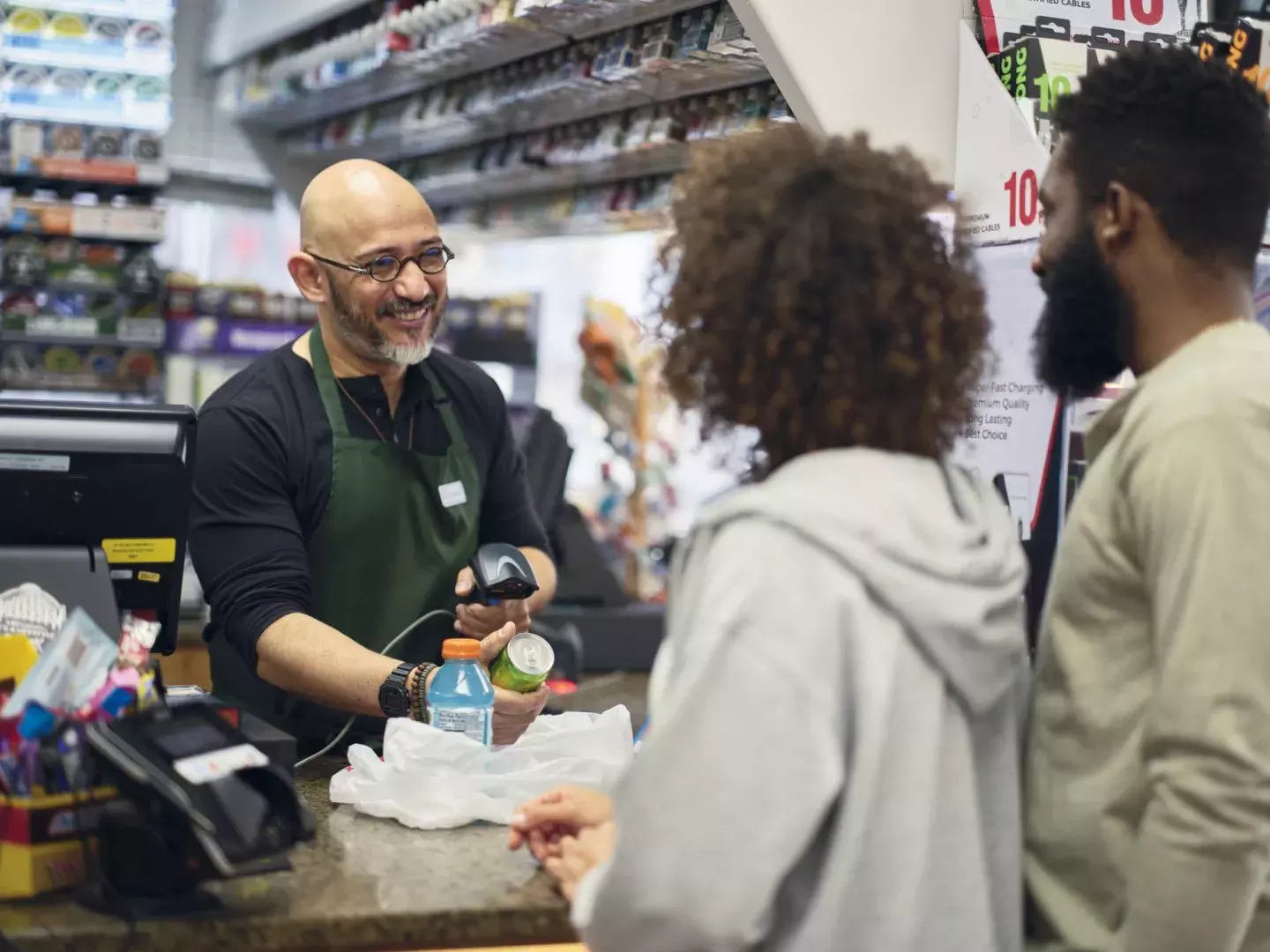 Couple checking out at convenience store